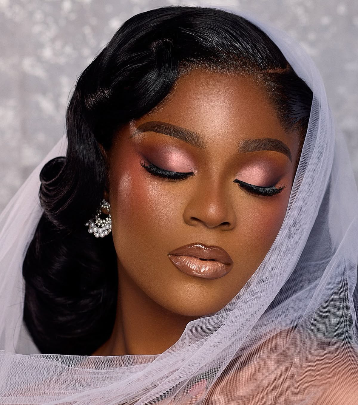 Makeup artist applying natural bridal makeup in a luxury studio